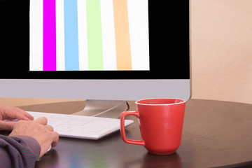 Person is working on his home computer during the morning