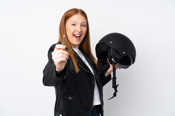 Young redhead woman with a motorcycle helmet over isolated white background