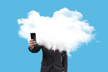 Businessman with his head in the clouds consulting with the mobile the economic crisis on blue...