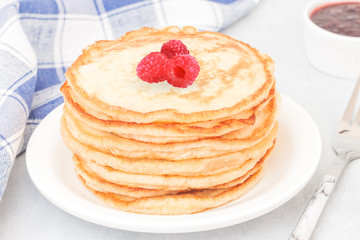 Classic american pancakes with raspberries jam