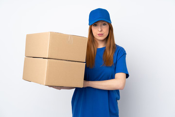 Young delivery woman over isolated white background keeping arms crossed