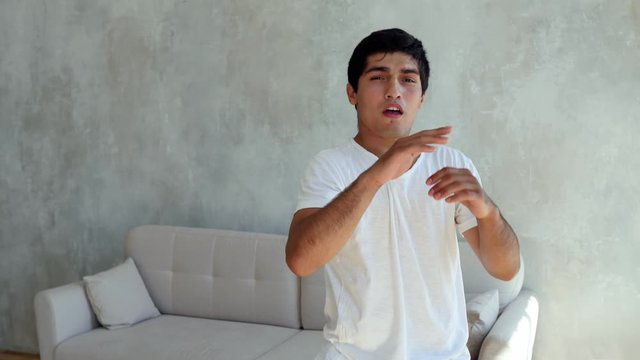 Kickboxer training at home. Athlete boxing to the camera. Medium shot with camera shake when a boxer hits. Self defense, sambo wrestler.