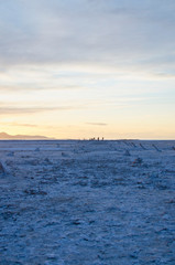 A long view of the empty and plain landscape of the great salt lake basin in the dusk sunlight.