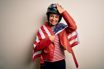 Middle age motorcyclist woman wearing motorcycle helmet and united states flag stressed with hand on head, shocked with shame and surprise face, angry and frustrated. Fear and upset for mistake.