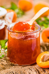 Apricot Jam with Fresh Apricot on Wooden Background. Selective focus.