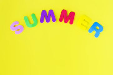 Colored letters forming the word summer on a yellow background