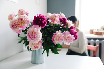 peonies in a garden watering can, a desktop in the home