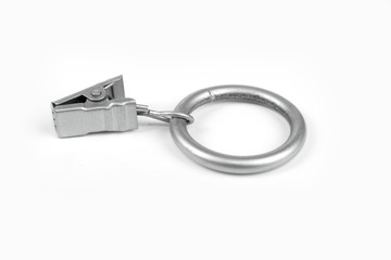 Metal curtain ring with clipper in a white background