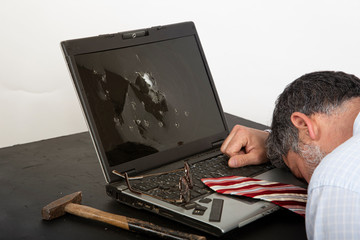 Angry businessman has broken his laptop to detoxify from teleworking.