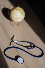 Globe and stethoscope. The concept of global warming and pollution. Phonendoscope and earth...