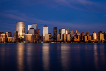 New York City skyline at twilight with reflection on the Hudson River