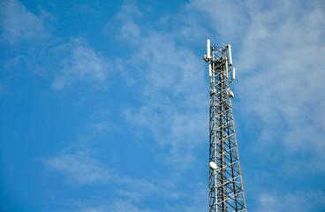 mobile phone tower on a background of blue sky and place for text