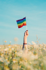 woman's hand holding an lgtb flag