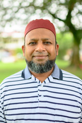 Senior Asian Muslim Man on portrait shot, looking at camera.