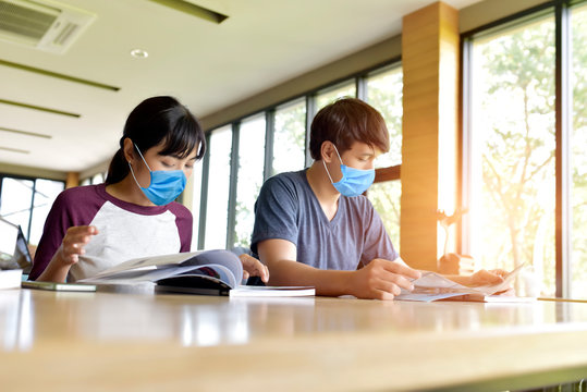 Teenage couple with protective mask During the study To avoid physical contact Coronavirus COVID-19 Disease Prevention