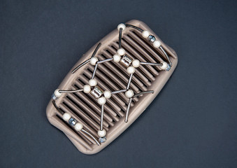 Hair clip closeup in bronze color with silver beads and pearls in this personal accessory object,...
