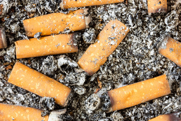 Close up of cigarette butts in ashtray.Stop smoking concept