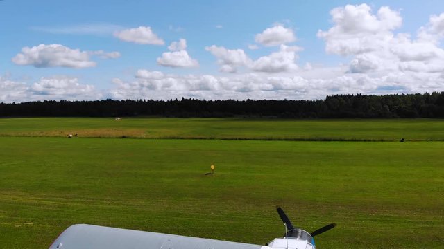 Light plane on green air field. Jet, aerial top view 4k