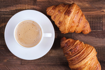 Directly above cap coffee cappuccino and two croissant