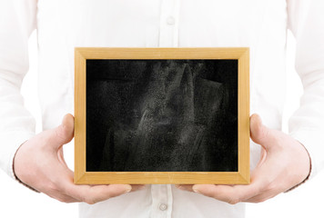 
Man on a white background holds a black wooden board in his hands