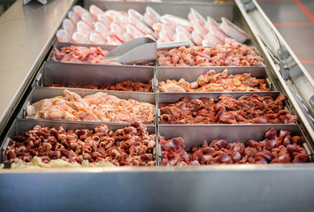Sorted Chicken Internal Organs for Sale at the Butcher's in a Supermarket.