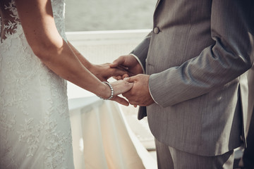 wedding ceremony bride and groom holding hands