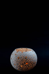 glass candle on black background