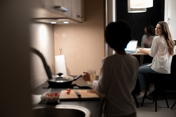 Pleased beautiful woman smiling at her son