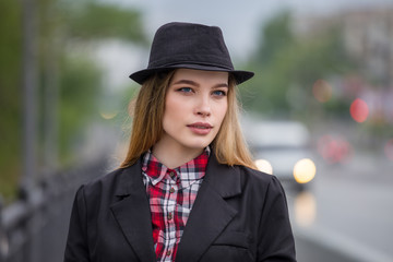 Portrait of a beautiful young woman on the streets of the city. Fashion photo.