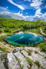 This is the biggest, and deepest (more than 100 meters deep), of all three wellsprings, of river Cetina, with the highest mountain in Croatia named Dinara, in the background.