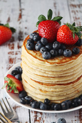 A stack if home-made pancakes with berry	