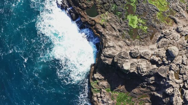 Wild Shoreline aerial view.Overhead aerial view of ocean waves crashing on rocky coast. Aerial view of stunning rocky coast on ocean.Forward establishing shot. Faroe Islands