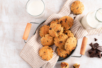 Chocolate chip cookies with milk bottles on white background