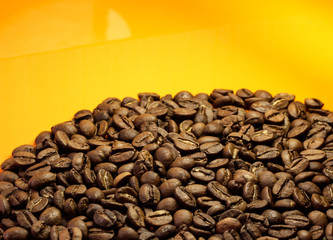 Coffee beans on a yellow background at the bottom.