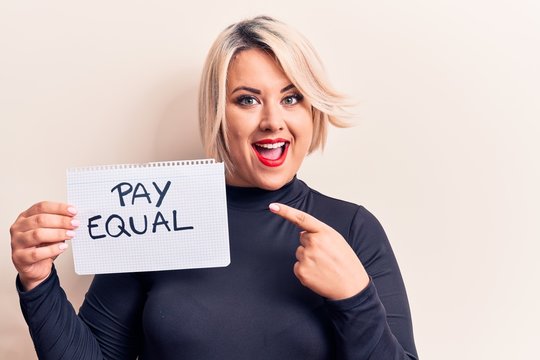 Beautiful plus size woman asking for equality economy holding paper with pay equal message smiling happy pointing with hand and finger