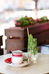 Vanilla Panna Cotta with Jelly of berries in glass jar. Italian dessert panna cotta. Classic Italian dessert creamy panna cotta with cherry sauce. Concept of pastry salon. Mojito and dessert.