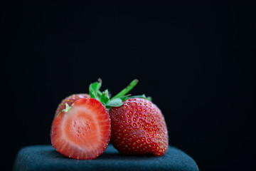fresh strawberries on a black background. Close-up shot. Macro