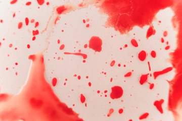 Fresh red blood splat on white porcelain with specks from the impact. Copy space area for horror...