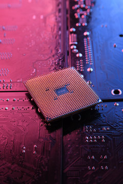 Computer cpu processor chip on circuit board ,motherboard background. Close-up. With red-blue lighting