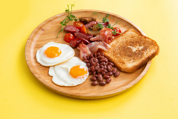breakfast fried eggs, bacon, beans and toast.