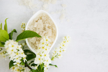 Concept of Spa-cosmetic and cosmetic procedures. Spa-sea salt in white dishes and seashells on...