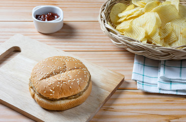 Delicious low fat hamburger and potato chips in basket with ketchup.  Ready to Eat.