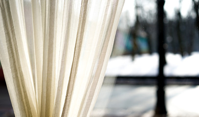 close up of a light beige cream curtain on the window, interior decoration, design detail