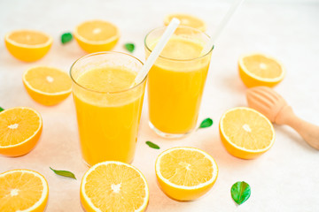 fresh orange Juice and oranges on the cutting board