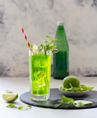 Carbonated iced tea with mint and lime in glass, refreshing drink