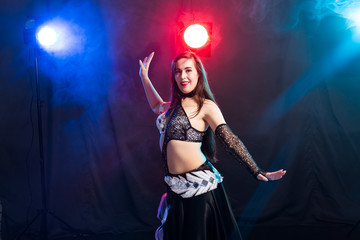 Portrait of a woman in oriental costume performing belly dance. Tribal fusion dance concept.