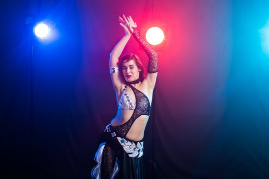 Girl dancing belly dance, fusion or tribal. A woman in a beautiful costume demonstrates charming and gentle movements in the dance.