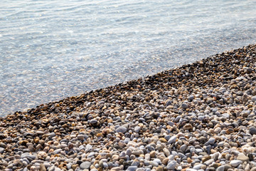 Natural background seashore and stones, pebble sea wave, landscape for calm