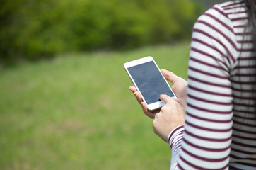 woman hand phone in nature