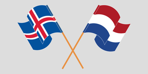 Crossed and waving flags of Iceland and the Netherlands